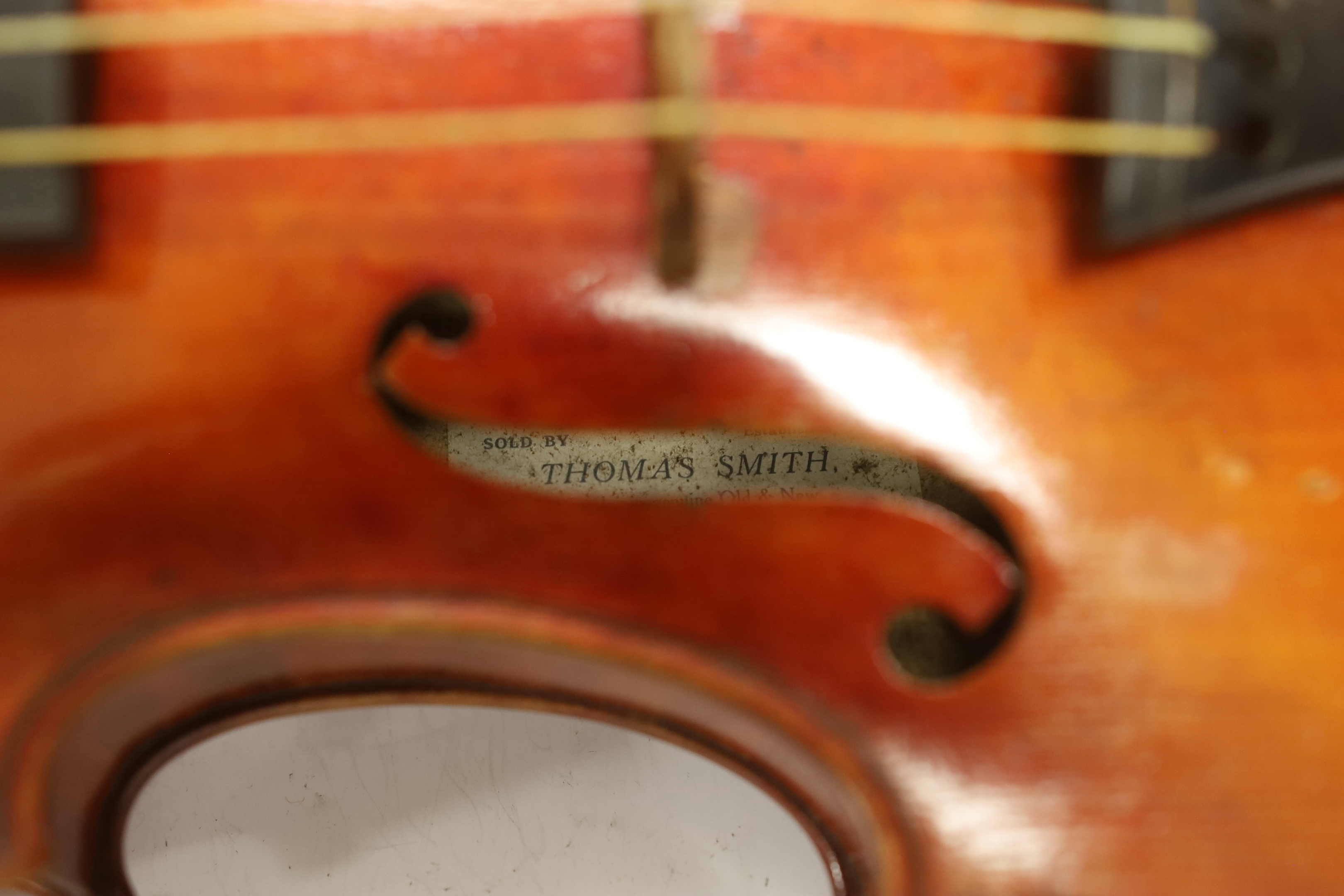 A French violin, c. 1900, with a retailer’s label inside the body for Thomas Smith, 183 Sherlock St. Birmingham, cased with a bow, body 35.5cm